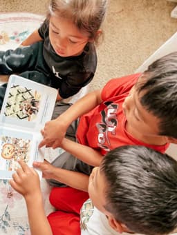 Overhead view of kids flipping through their personalized board book